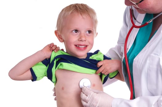 Doctor examines a young child. The doctor examines the child and listening to the heart and lungs with her stethoscope. He helps doctor by lift his shirt up so the nurse can come to listen to the boy&#39 s chest