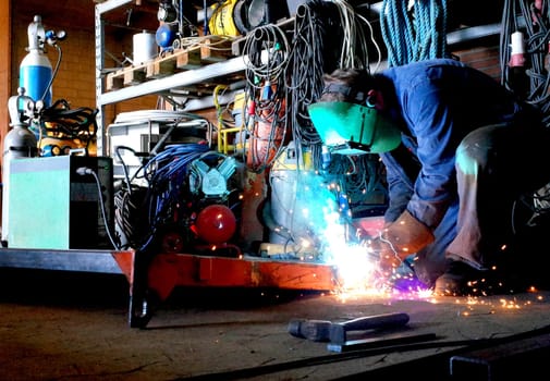 Welder in work with welding in the workshop
