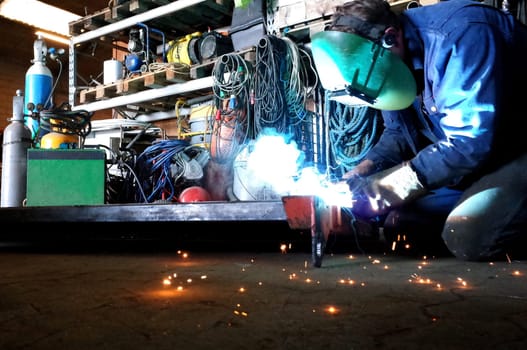 Welder in work with welding in the workshop