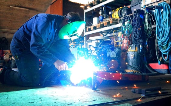 Welder in work with welding in the workshop