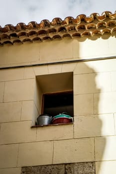 window opening with pots and pans in sunshine