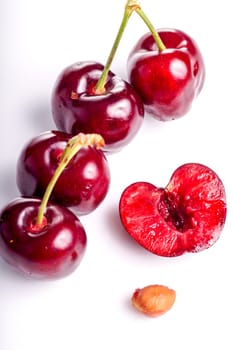 Cherry. Red Ripe Organic Fruit. One half berry and copy space. Cherries