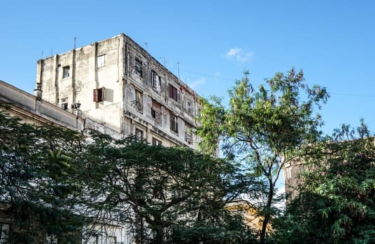 Slum facade with trees and blue sky