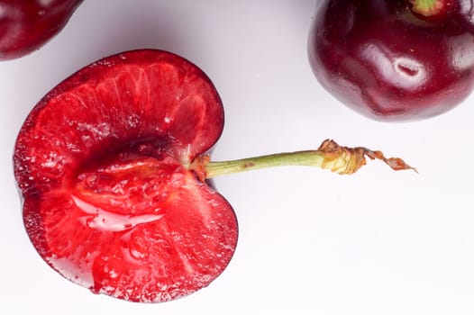 Cherry. Red Ripe Organic Fruit. One half berry and copy space. Cherries