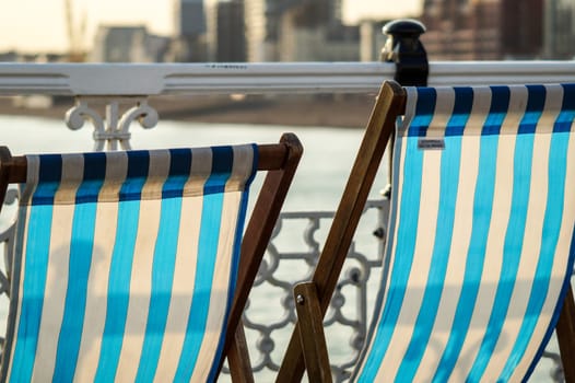 Empty Deckchairs overlooking the water in the sunny summer