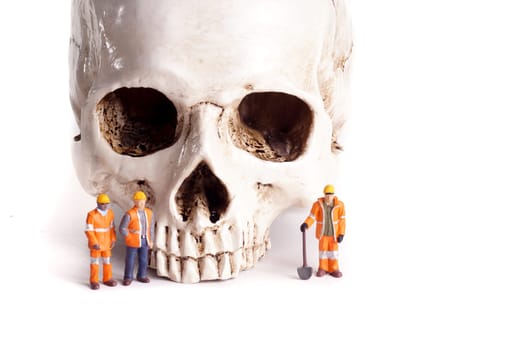 Skull and small workers, work accidents , dangerous work, take care of yourself