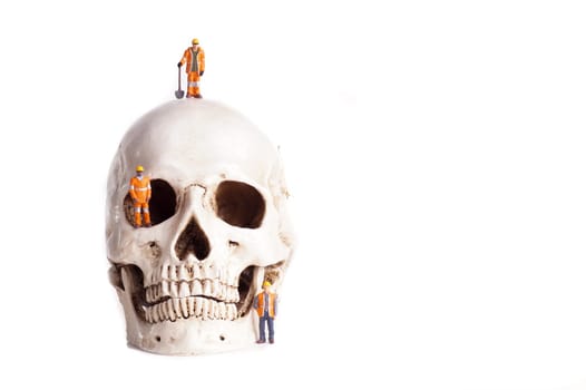 Skull and small workers, work accidents , dangerous work, take care of yourself