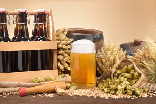 Beer carriers,beer barrels and beer glasses with wheat,barley,hops and malt