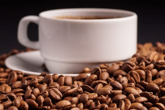 Coffee in a cup and a pile of Coffee Beans