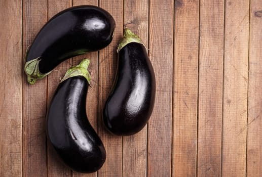 Healthy Organic Eggplant, lying on a wooden board