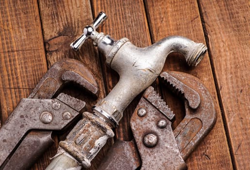 plumbing tools lying with old pipes and faucets