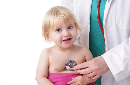 The doctor examines toddler child and listening to heart and lungs with stethoscope. The baby girl is happy, isolated on white
