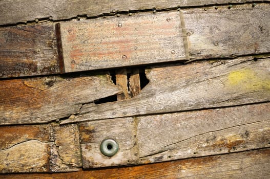 Close up view of the damage in an old wooden logs shipwrecks