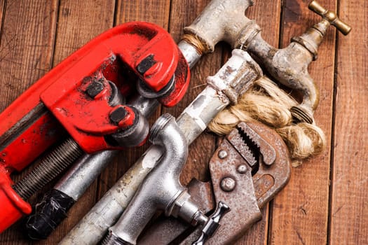 plumbing tools lying with old pipes and faucets