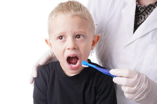 Young Boy gets help by the Dentist to brush his teeth, Isolated on white