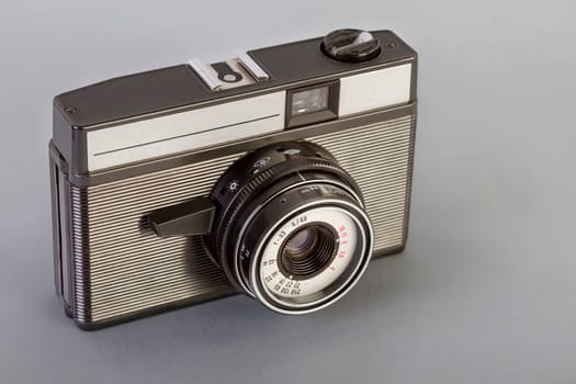 Vintage photo camera on a gray table..