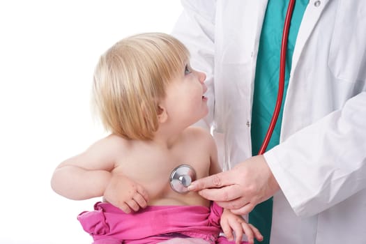 The doctor examines toddler child and listening to heart and lungs with stethoscope. The baby girl is happy, isolated on white