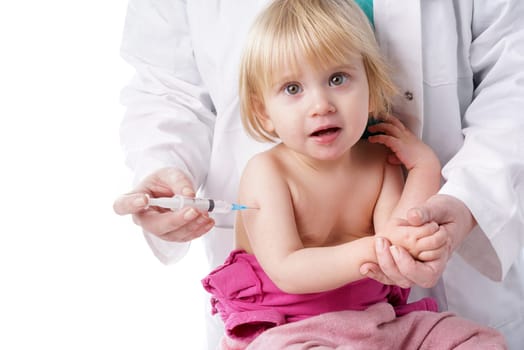 Doctor gives baby girl an injection. The doctor gives the child an injection in the upper arm . It can be both a vaccination or as part of the girl&#39 s medical treatment