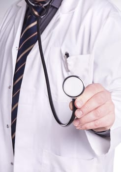 doctor with stethoscope in hand. Copy space and isolated