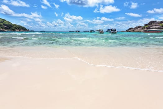 Landscape beautiful blue sea and summer sky above the bay front beach was used as a quay speed boat of tourist at Koh Similan Islands in Mu Ko Similan National Park, Phang Nga province, Thailand