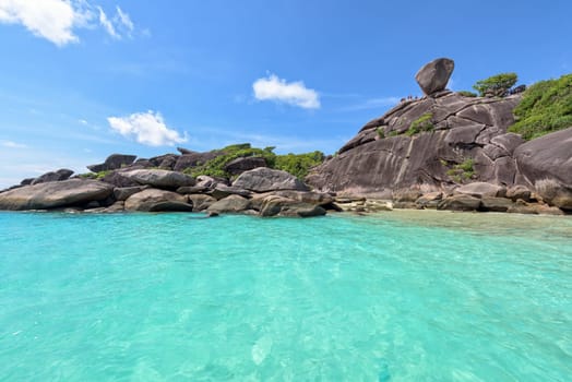 Beautiful landscape people on rock is a symbol of Similan Islands, blue sky and cloud over the sea during summer at Mu Ko Similan National Park, Phang Nga province, Thailand