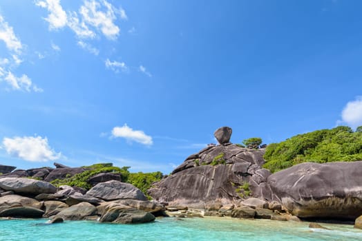 Beautiful landscape people on rock is a symbol of Similan Islands, blue sky and cloud over the sea during summer at Mu Ko Similan National Park, Phang Nga province, Thailand