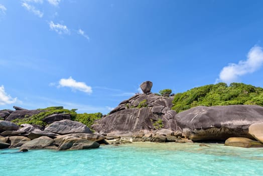 Beautiful landscape people on rock is a symbol of Similan Islands, blue sky and cloud over the sea during summer at Mu Ko Similan National Park, Phang Nga province, Thailand
