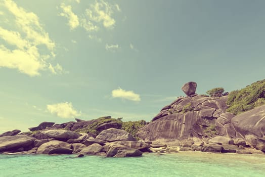Vintage style beautiful landscape people on rock is a symbol of Similan Islands, blue sky and cloud over the sea during summer at Mu Ko Similan National Park, Phang Nga province, Thailand