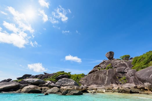 Beautiful landscape people on rock is a symbol of Similan Islands, sun on blue sky over the sea during summer at Mu Ko Similan National Park, Phang Nga province, Thailand