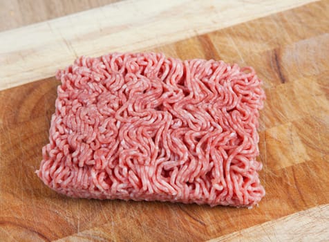 raw mixed minced pork and beef fresh on a wooden board