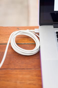 Charge battery laptop on work station, stock photo