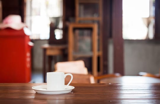 White coffee cup on wooden table in coffee shop