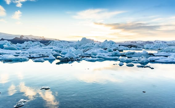 Beautiful view of icebergs in Jokulsarlon glacier lagoon at sunset, Iceland   selective focus