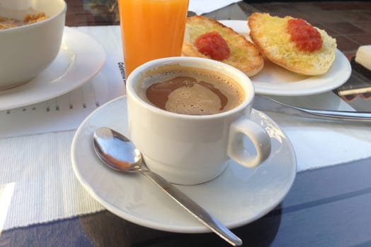 Spanish breakfast with tomatoe and oil toast, orange juice and coffee with milk