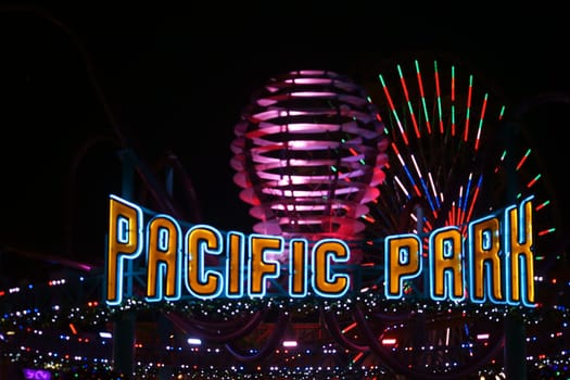 Santa Monica,United States - December 28,2015: The shrill entrance sign of the Pacific Park amusement park on Santa Monica Pier at night on December 28,2015 in Santa Monica.