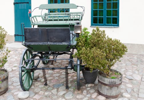 one old horse wagon standing outside the house