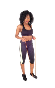 An African American woman in exercise outfit with a rope standing.isolated for white background..
