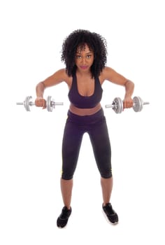 A beautiful African American girl working out with two dumbbell's in.exercise outfit, isolated for white background..