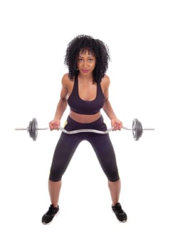 A young pretty African American woman in exercising outfit lifting weight,.with black curly hair, isolated for white background..
