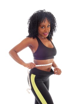 A lovely young African American woman measuring her waist in exercise.outfit and curly black hair, isolated for white background..