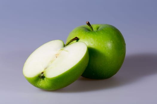 Granny Smith Apples. One sliced and one whole.