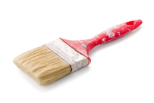 Red used paint brush on a white background.