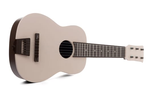 Beige guitar toy isolated on white background.