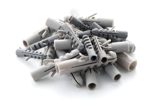 Grey plastic dowels isolated on white background.