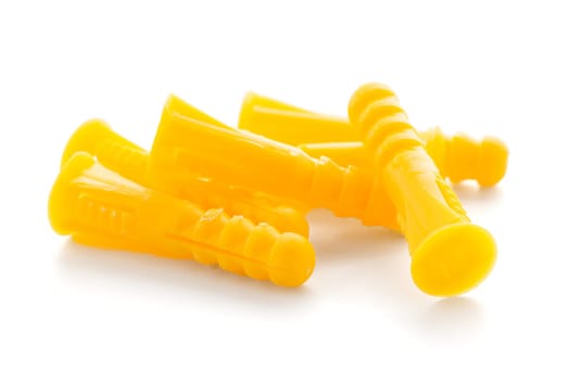 Yellow plastic dowels isolated on white background.