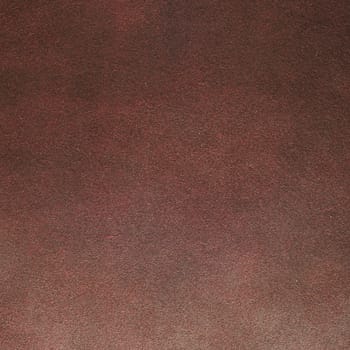 Red leather texture closeup background.