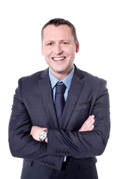 Happy middle aged businessman with folded arms