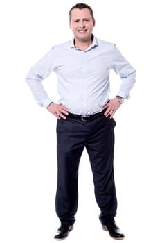 Handsome man posing over white with hands on waist