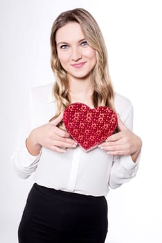 Woman holding gift box in form of heart