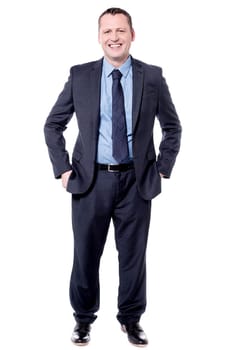 Full length image of male executive with hands in pockets